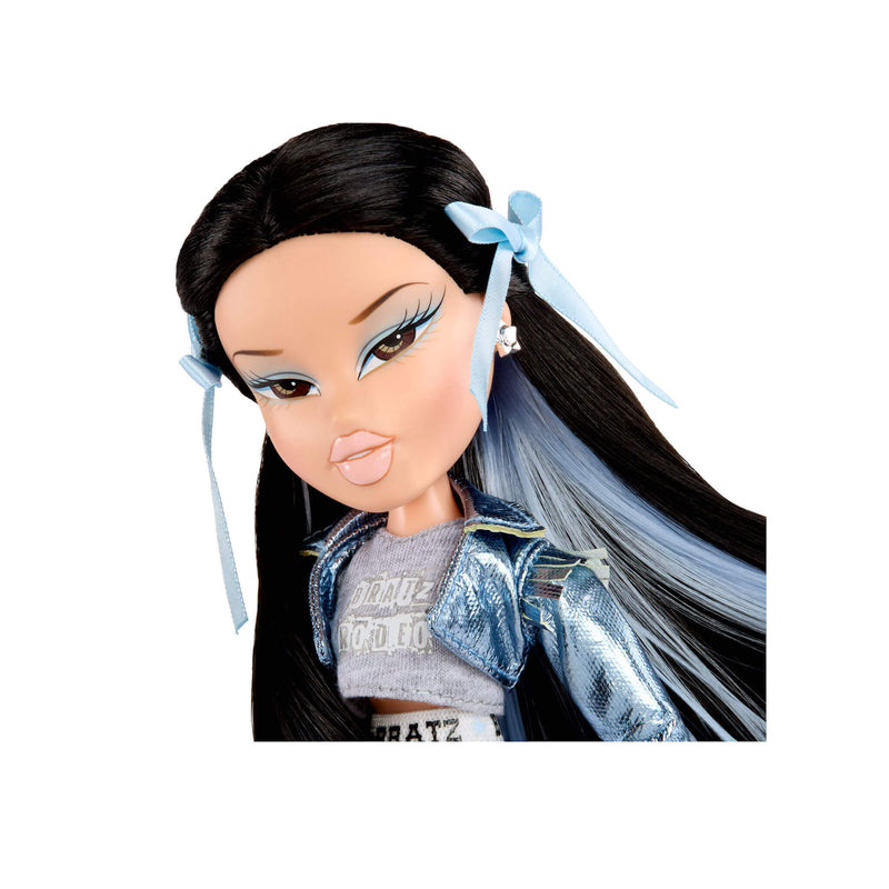 Doll with long black and blue hair with bows, wearing a blue jacket and gray top on a white background