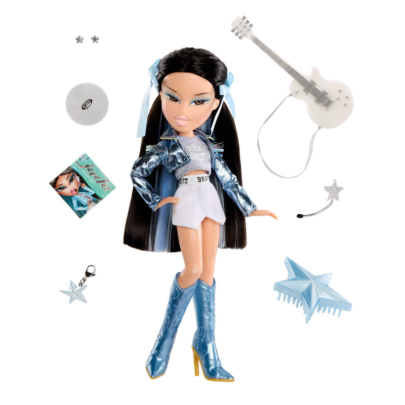 Doll with long black hair, shiny jacket, and high boots, surrounded by accessories on a white background