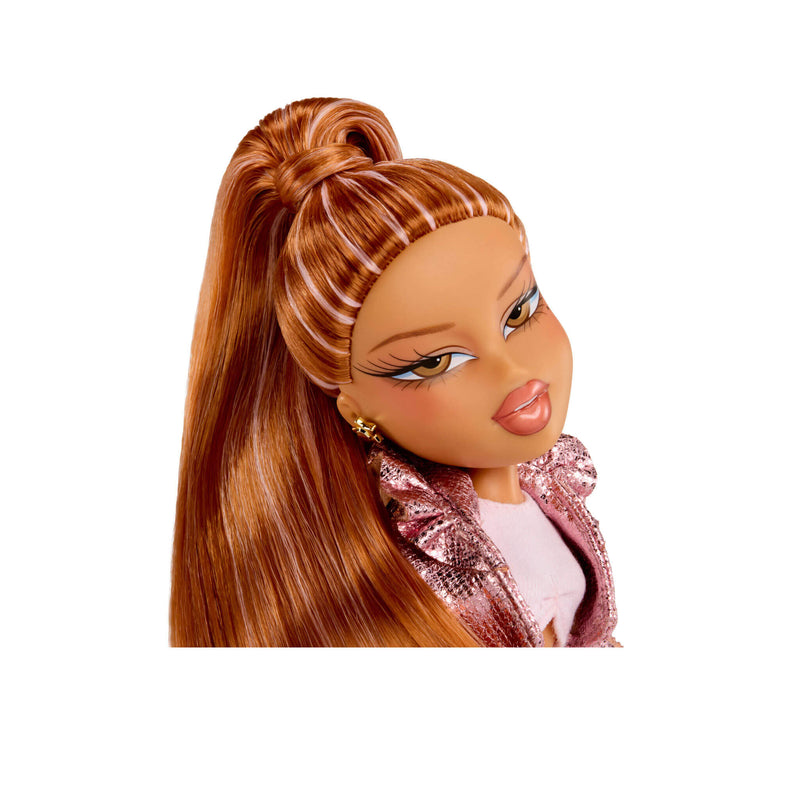 Close-up of a doll with brown hair styled in a high ponytail, wearing a pink jacket.