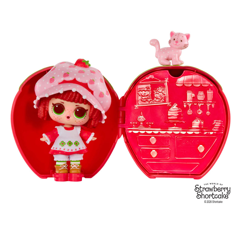 Strawberry Shortcake doll by a strawberry shaped case with a kitty on top, on a white background.