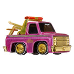 Toy Tow -truck with pink body, gold wheel rims, and a tow hook on a white background