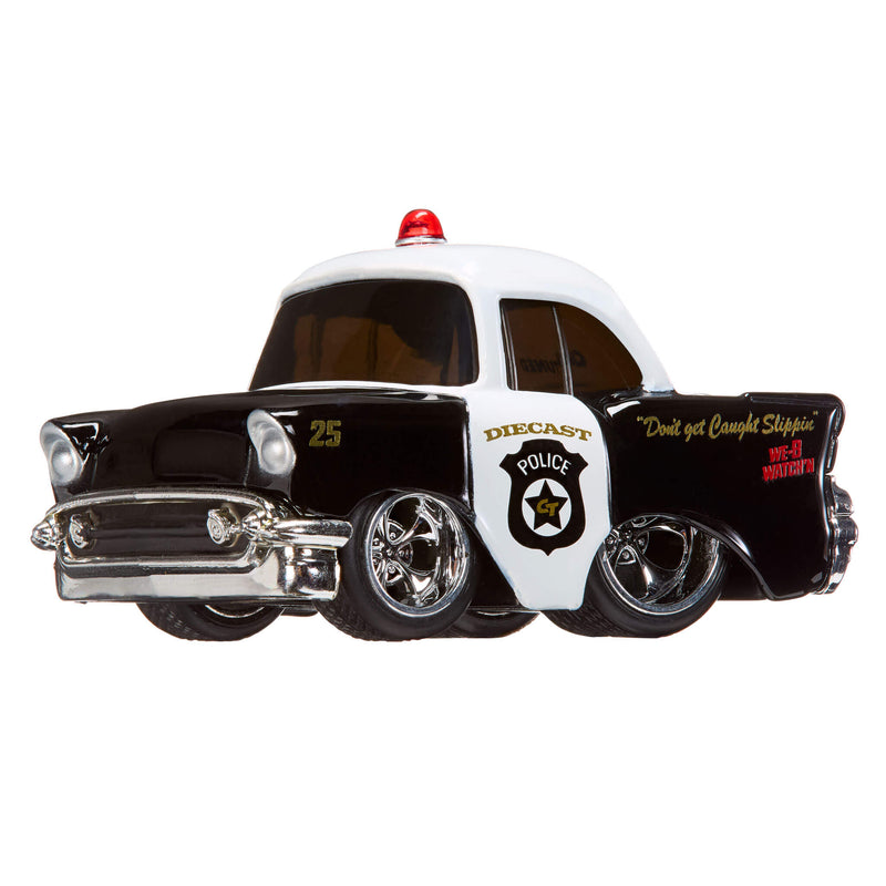 Toy police car with a red light on top, black and white color scheme, and visible branding.