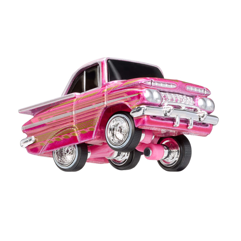 Pink toy car with chrome hub caps, front end lifted on a white background