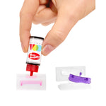 Hand holding a small cartridge with colorful design, white background