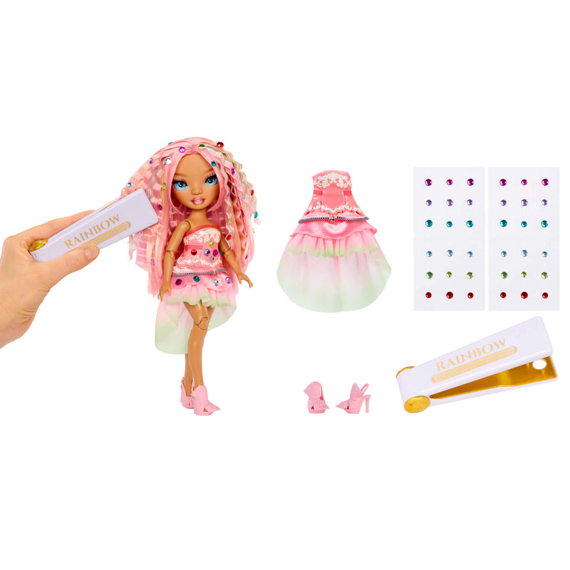 Toy doll with pink hair and outfit, including the gem tool and accessories on a white background
