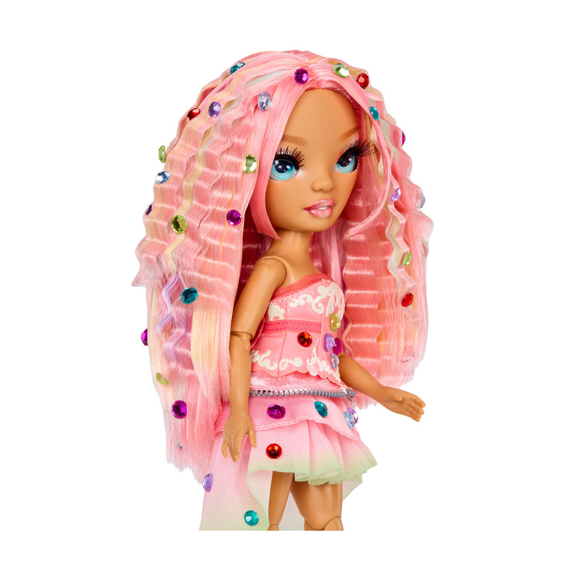 Toy doll with gems in her pink hair and on her pink dress on a white background