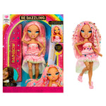 Toy doll with pink hair and dress next to its packaging