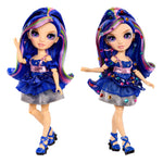Two dolls one with gems and one without gems with colorful purple hair and outfits on a white background