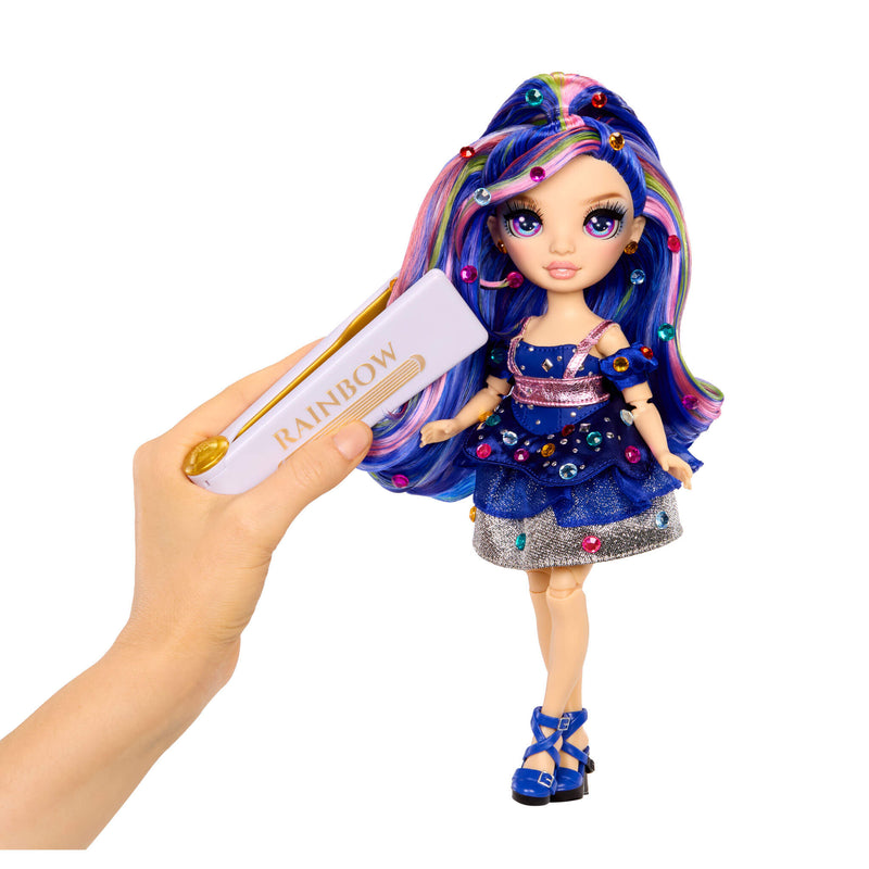 Doll with colorful hair and outfit, next to a Hand holding a bedazzling tool with 'Rainbow' text on a white background