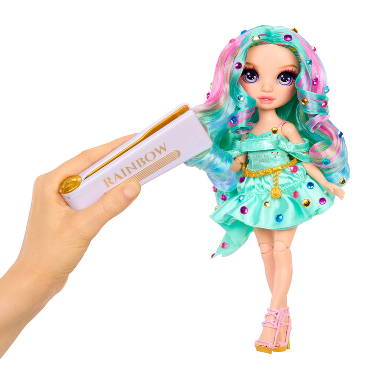 Doll with colorful hair and bedazzling tool held by a hand, with  'Rainbow' text on a white background.