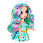 Doll with gems in her teal, colorful hair and teal outfit on a white background