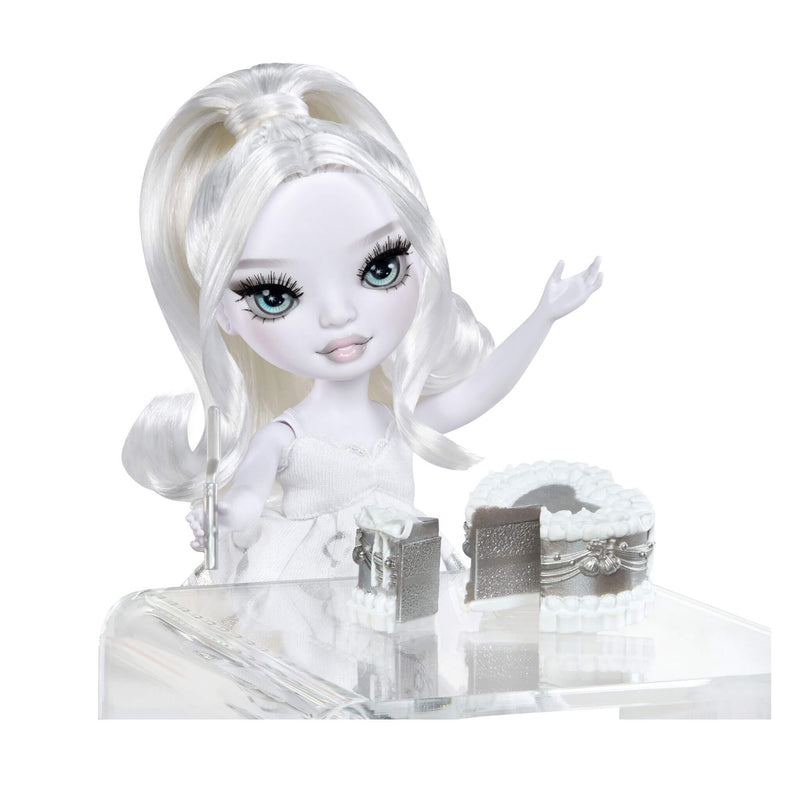 White doll with long hair sitting at a clear stand against a white background
