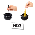 Two black cauldron-shaped containers with spoons and a sign saying 'MIX!' on a white background.