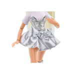 Doll wearing a silver dress with a white background