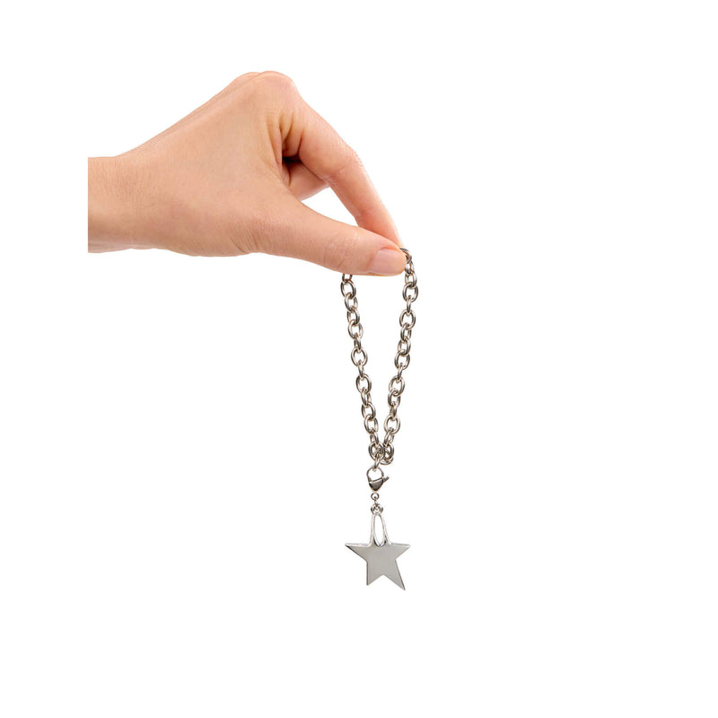 Hand holding a silver bracelet with a star pendant on a white background