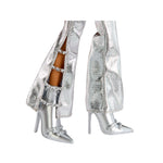 Silver high-heeled shoes with embellishments on a white background