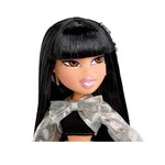 Doll with long black hair and a decorative outfit on a white background