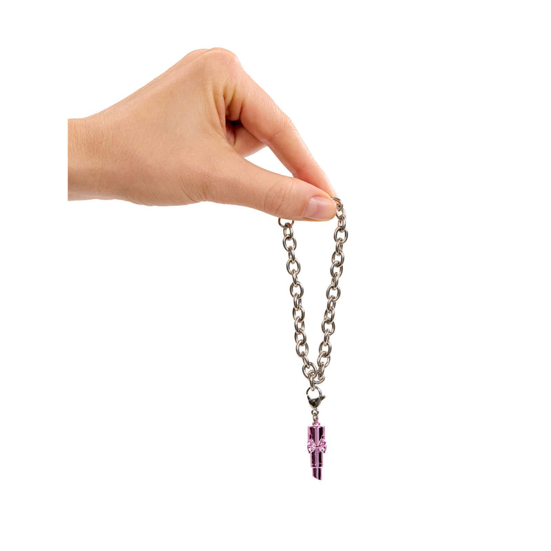 Hand holding a bracelet with a purple crystal pendant on a white background
