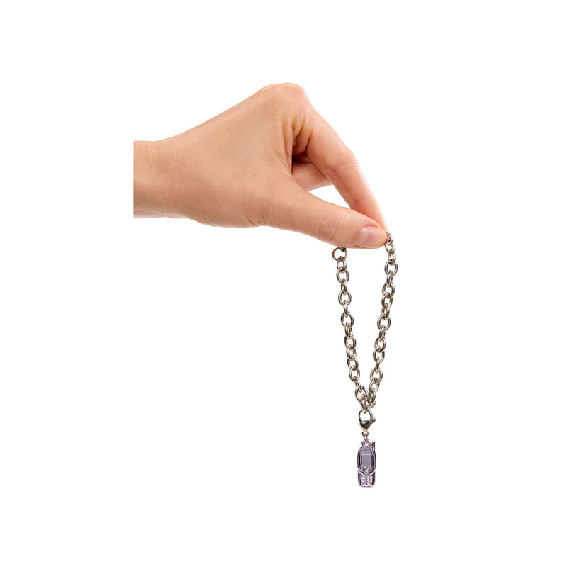 Hand holding a bracelet with a purple crystal pendant on a white background