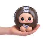 Brown Hostess Cupcake  stuffed toy with a face held in a hand on a white background