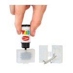 Hand holding a small cartridge with colorful design, filling a mold on a white background