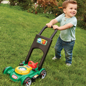 Boy pretending to cut grass with Toy Mower