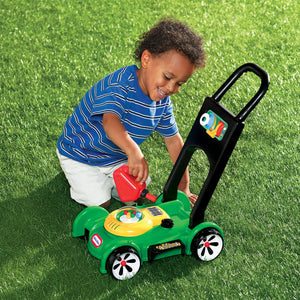Boy pretending to fill toy lawn mower
