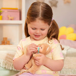 Child playing with a teddy bear in a cozy room
