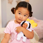 Child holding a baby dog doll 