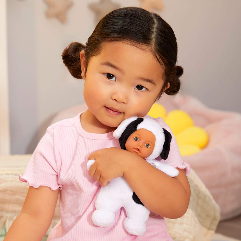 Child holding a baby dog doll 