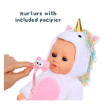 Baby doll in unicorn costume with pacifier held by hand on a white background
