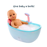 Toy baby in a bathtub with bubbles and a toy shower head, on a white background with text 'Give baby a bath!'.