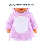 Doll wearing a pink onesie with a white circle on a white background