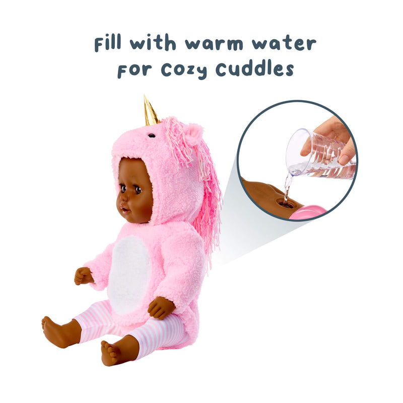 Toy doll in a pink unicorn costume with text 'Fill with warm water for cozy cuddles' and an inset showing water being poured.