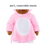 Doll wearing a pink plush outfit with text 'Soft, removable onesie' on a white background