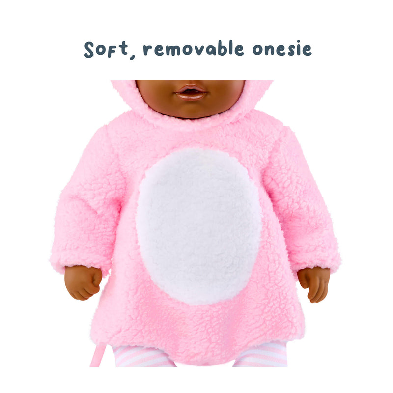 Doll wearing a pink plush outfit with text 'Soft, removable onesie' on a white background