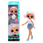 Toy doll with pink hair and blue shoes next to its packaging