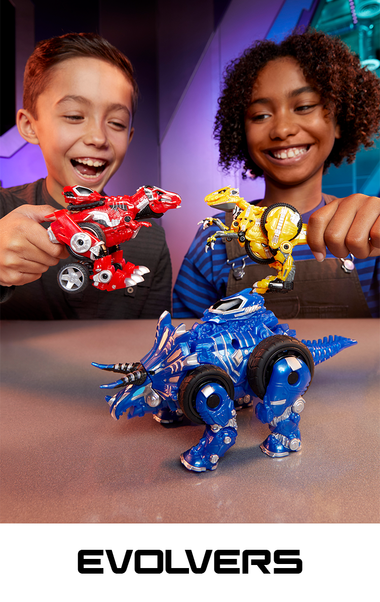 Two children holding red and yellow toy evolvers with a blue evolver on a table, branded 'Evolvers'. Click to shop Evolvers