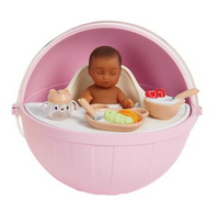 dark skinned baby in a pink high chair with food and utensils on a white background