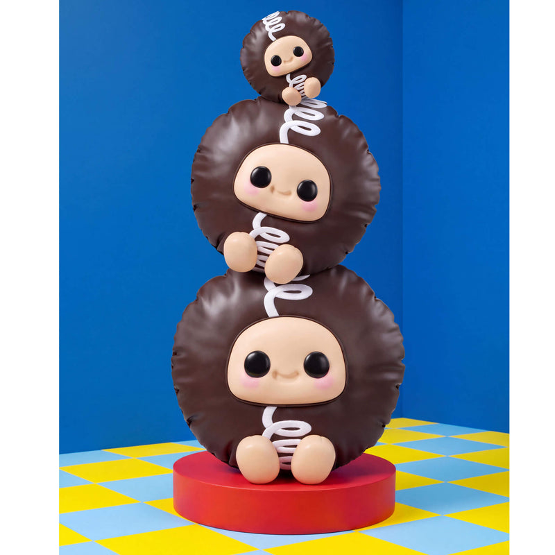 Three different sizes of Hostess Cupcake stacked on a blue background