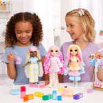 Girls tie-dying dolls clothes