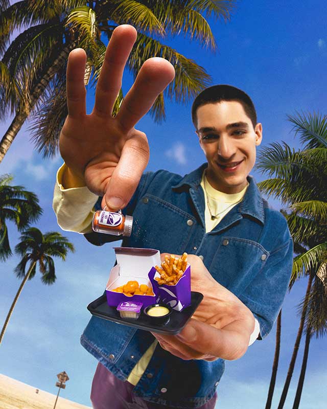 Person holding a Miniverse Taco Bell with palm trees in the background