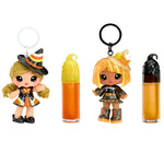 Cassie Treats and Blair Treats Halloween-themed keychains with small dolls and lip balms on a white background