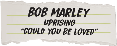 Torn piece of paper with text 'Bob Marley Uprising Could You Be Loved' on a white background
