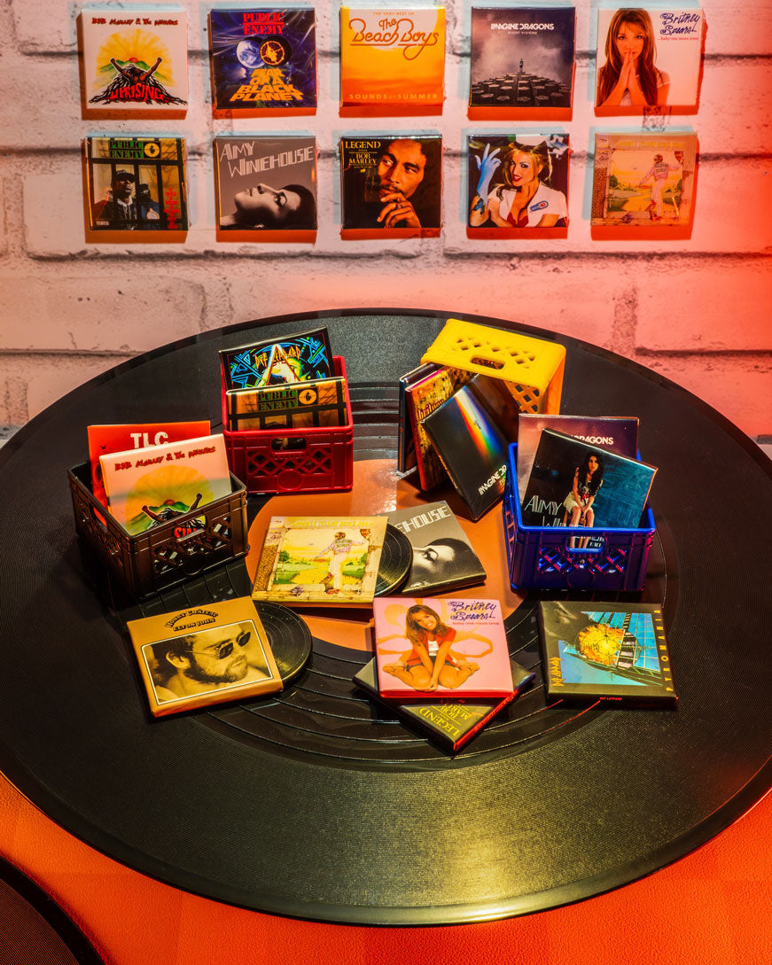 Collection of Miniverse music albums displayed on a record with a brick wall background